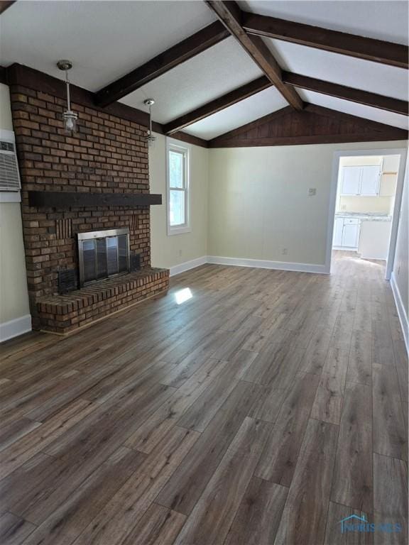 unfurnished living room with lofted ceiling with beams, a brick fireplace, and dark wood-type flooring