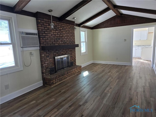 unfurnished living room featuring dark hardwood / wood-style flooring, an AC wall unit, and a healthy amount of sunlight