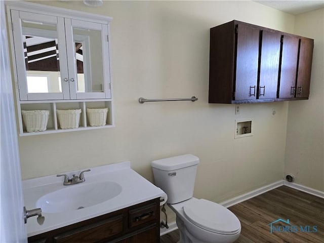 bathroom with hardwood / wood-style flooring, vanity, and toilet