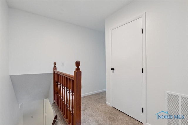 hallway with light colored carpet