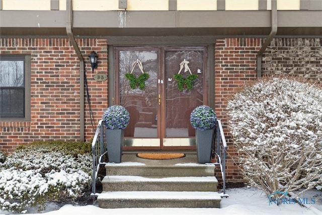 view of snow covered property entrance