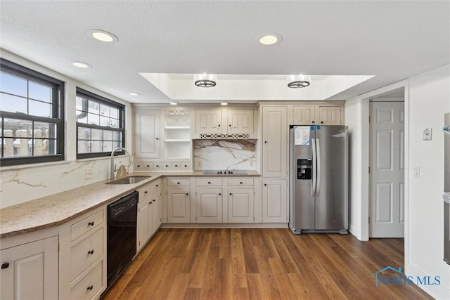 kitchen featuring stainless steel refrigerator with ice dispenser, sink, dishwasher, hardwood / wood-style floors, and decorative backsplash