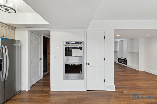 interior space featuring stainless steel appliances and dark hardwood / wood-style flooring