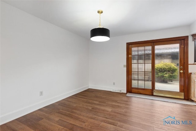 empty room featuring dark hardwood / wood-style floors