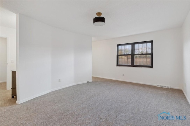 unfurnished room with light colored carpet