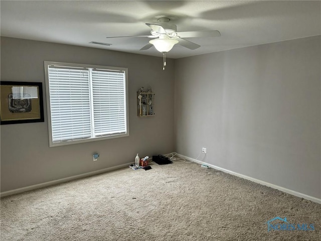 empty room with ceiling fan and carpet