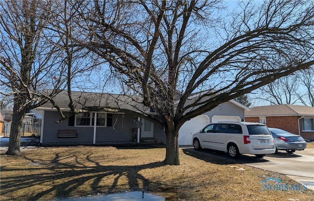 view of front of property with a garage and concrete driveway