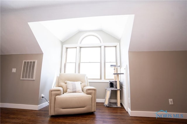 living area featuring vaulted ceiling and dark hardwood / wood-style floors