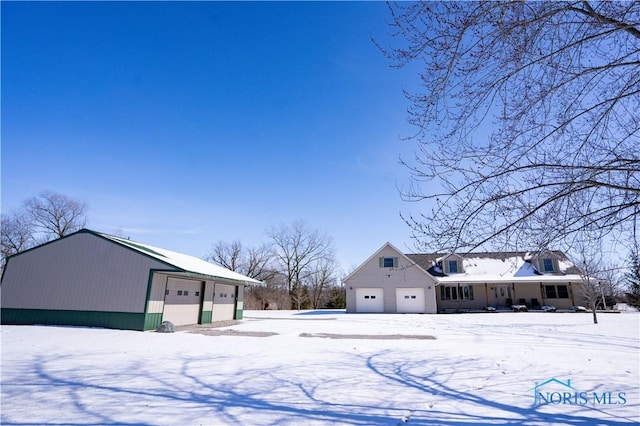 yard covered in snow featuring a garage