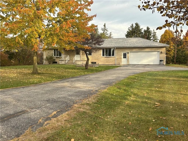 view of front facade featuring a garage and a front lawn