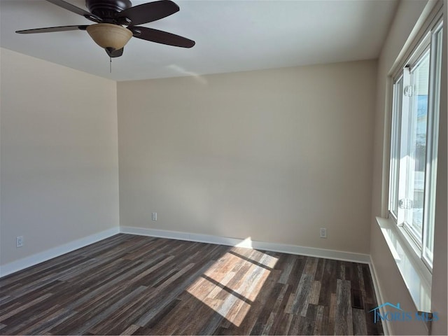 spare room featuring plenty of natural light and dark hardwood / wood-style floors