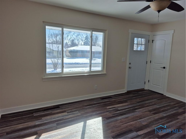 foyer entrance with ceiling fan and dark hardwood / wood-style floors