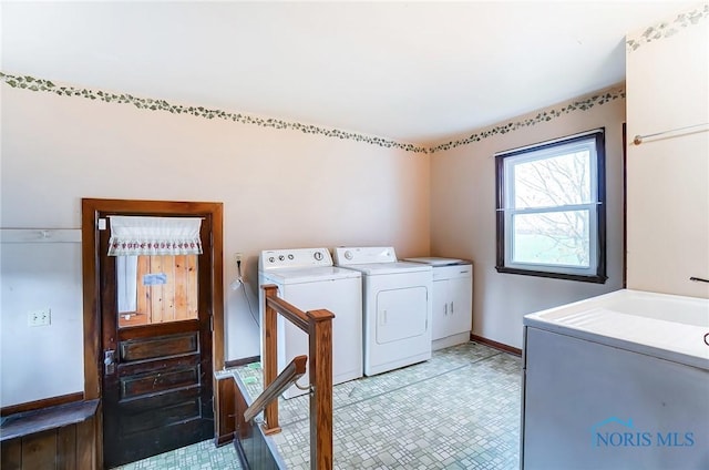 clothes washing area featuring separate washer and dryer