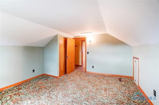 bonus room featuring carpet flooring and vaulted ceiling