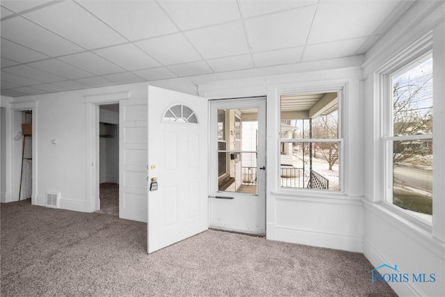 unfurnished sunroom with a drop ceiling