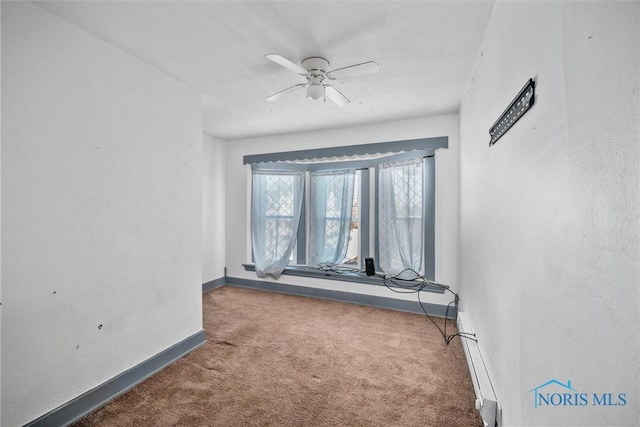 unfurnished room featuring ceiling fan and carpet