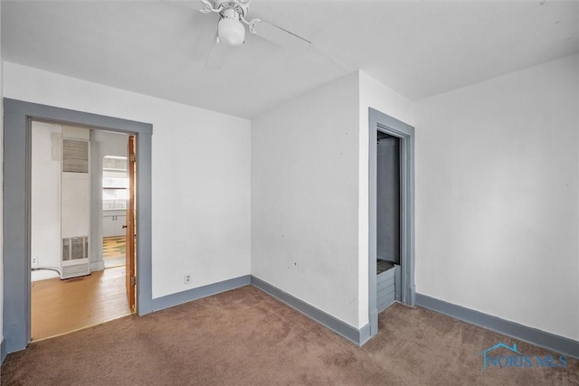 unfurnished bedroom featuring ceiling fan and dark colored carpet