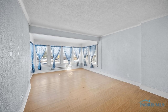 unfurnished room featuring hardwood / wood-style flooring, crown molding, and a textured ceiling