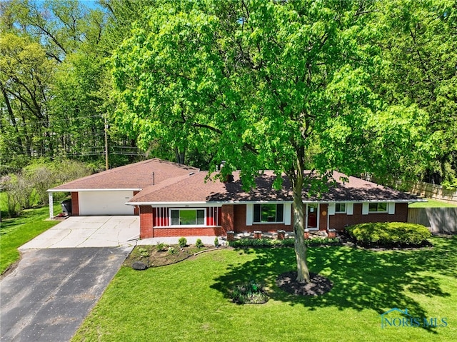 4811 Larkhaven Dr, Toledo, OH 43623 - ranch-style home featuring concrete driveway, brick siding, an attached garage, a front yard, and a chimney