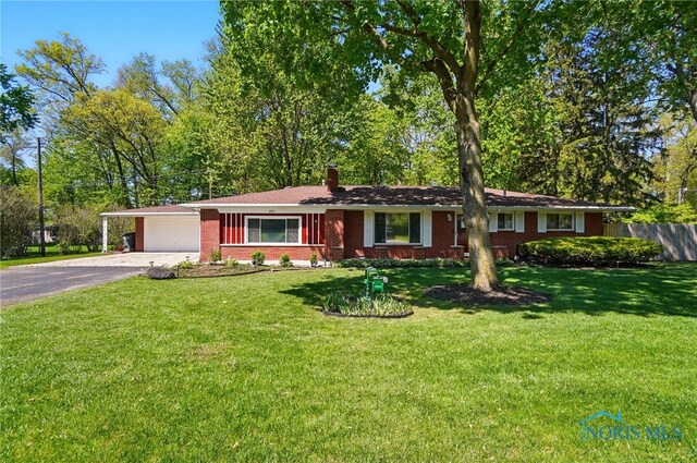 4811 Larkhaven Dr, Toledo, OH 43623 - single story home featuring asphalt driveway, a chimney, brick siding, a garage, and a carport