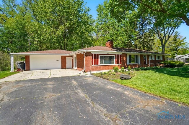 4811 Larkhaven Dr, Toledo, OH 43623 - single story home with driveway, brick siding, a front yard, a chimney, and a garage