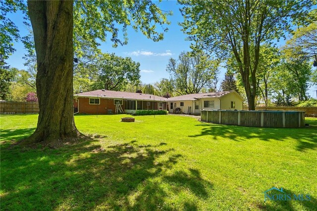 4811 Larkhaven Dr, Toledo, OH 43623 - view of yard featuring a fire pit and a pool