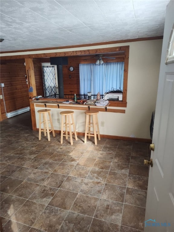 interior space featuring crown molding and baseboards