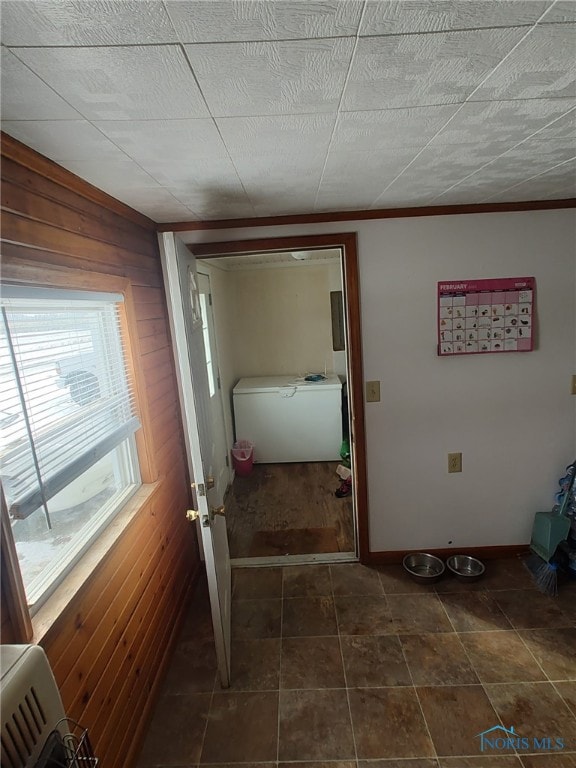 hall with wood walls and baseboards