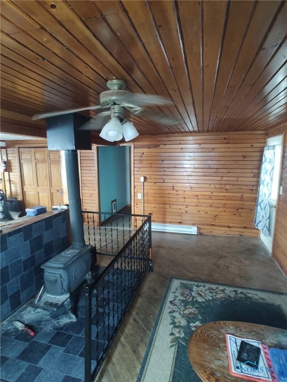 interior space featuring an upstairs landing, wood ceiling, and wooden walls