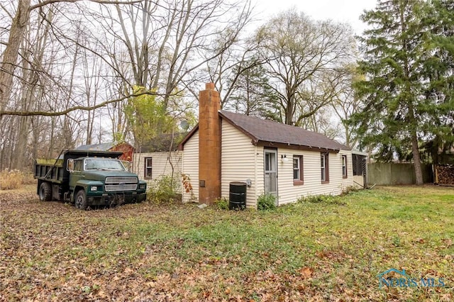 view of home's exterior featuring a yard and central air condition unit