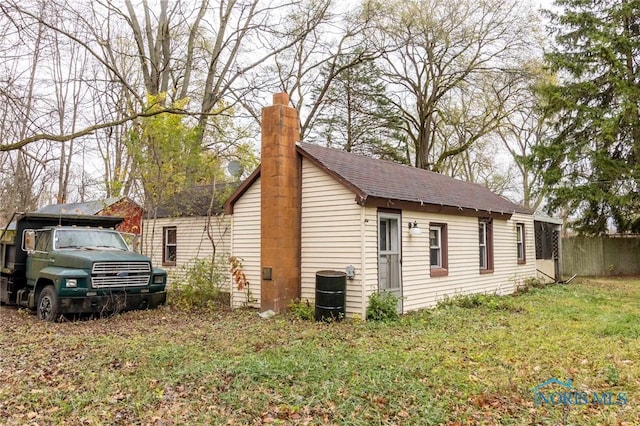 view of side of property with a lawn