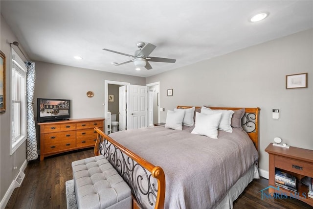 bedroom featuring connected bathroom, dark hardwood / wood-style floors, and ceiling fan