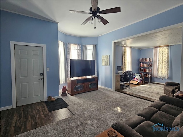 carpeted living room featuring crown molding and ceiling fan