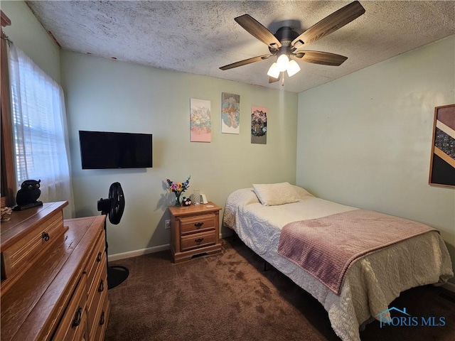 carpeted bedroom featuring a textured ceiling and ceiling fan