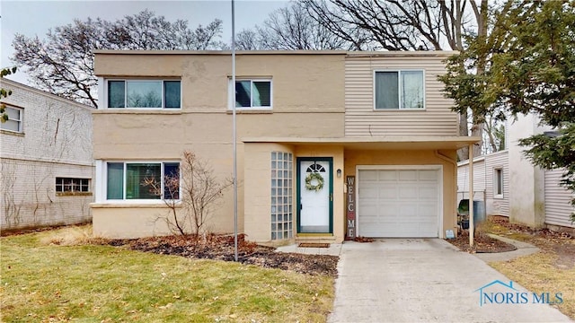 multi unit property with concrete driveway, an attached garage, and stucco siding