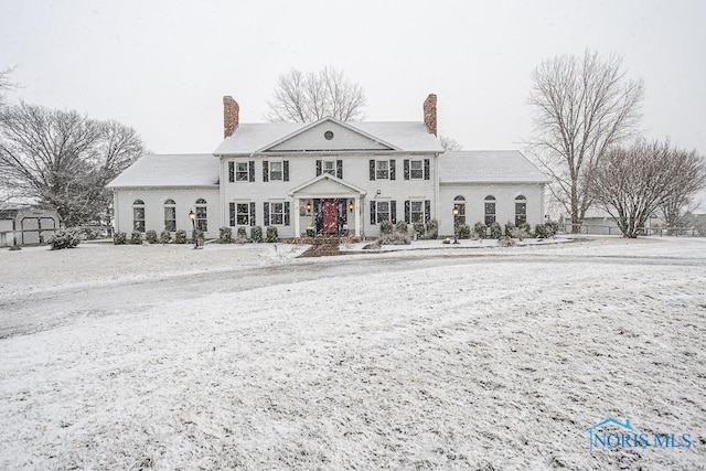 view of front of house featuring a chimney