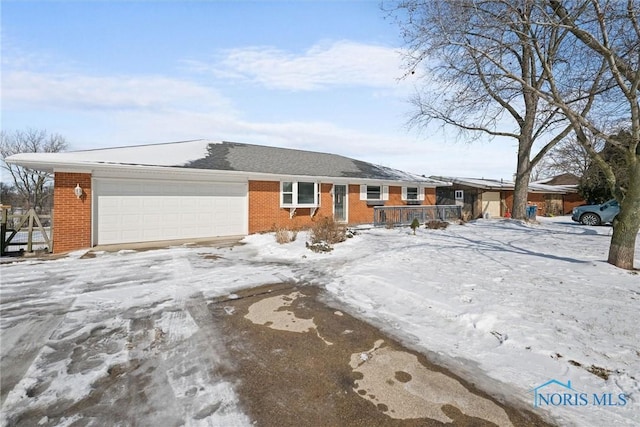 single story home with an attached garage and brick siding