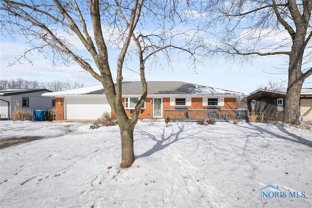 single story home featuring brick siding and an attached garage