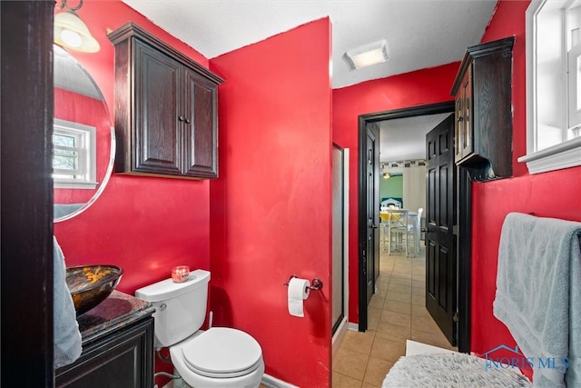 bathroom with tile patterned flooring, vanity, and toilet