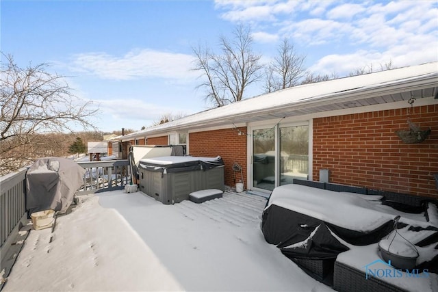 snow covered deck featuring area for grilling