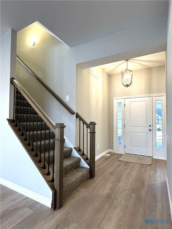 entrance foyer featuring a chandelier and hardwood / wood-style floors