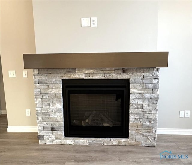 room details featuring a fireplace and wood-type flooring