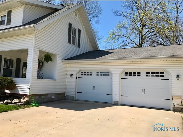 view of property exterior featuring driveway and an attached garage