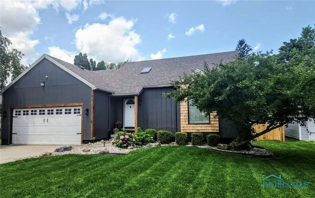 view of front of house featuring driveway, a front lawn, and an attached garage