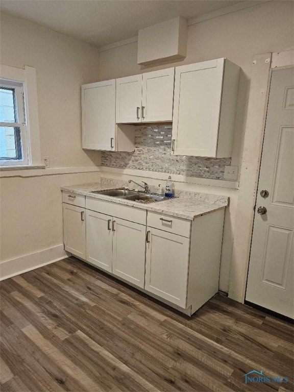 kitchen with sink, backsplash, dark wood-type flooring, and white cabinets