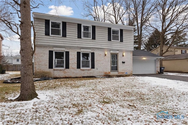 view of front of property with brick siding and an attached garage