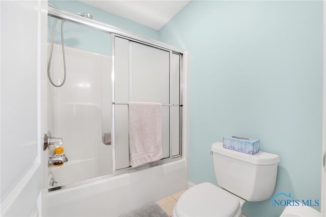 bathroom featuring shower / bath combination with glass door and toilet