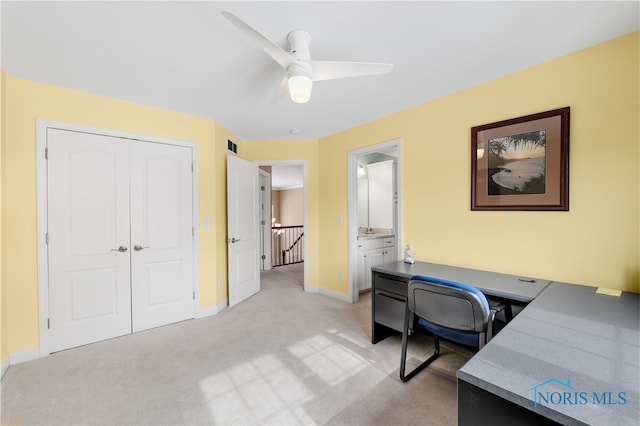 home office featuring visible vents, light carpet, baseboards, and ceiling fan