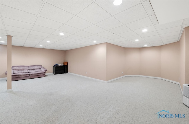 finished below grade area with recessed lighting, a drop ceiling, baseboards, and carpet floors