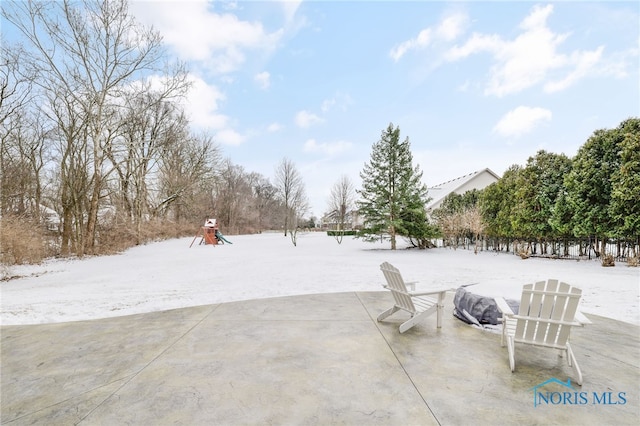 yard layered in snow with playground community